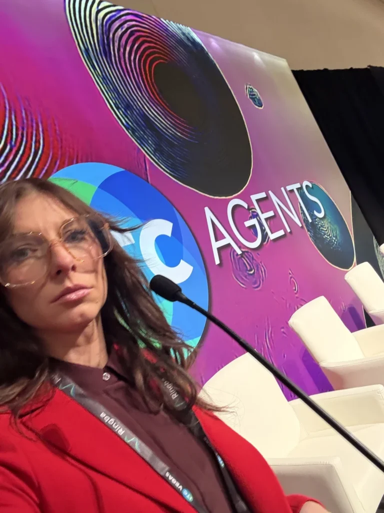 Whit Hope at ITC Vegas during the Cold Call Is Dead campaign, wearing a red blazer beside a microphone.